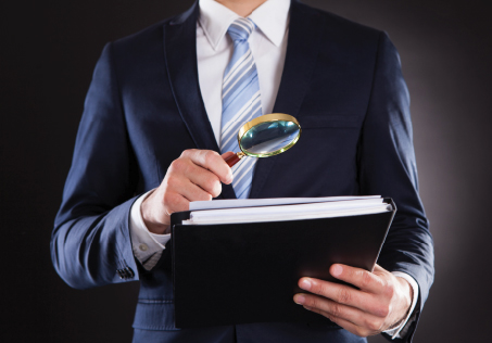 Licensed investigator reviewing a contractor's background file